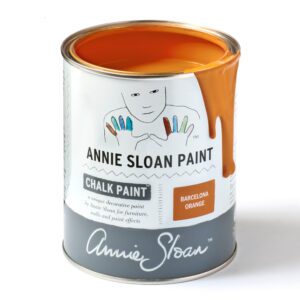 A can of Annie Sloan chalk paint with orange color.