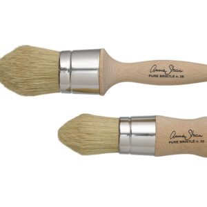 Two wooden-handled paintbrushes with natural bristles and metal ferrules.
